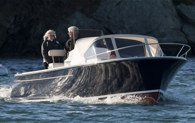 21 foot century boats for sale, navy blue boat on the water with couple talking, cruising on a lake 