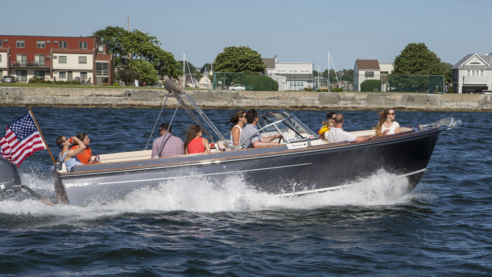 group of ten people cruising on a dual console boat